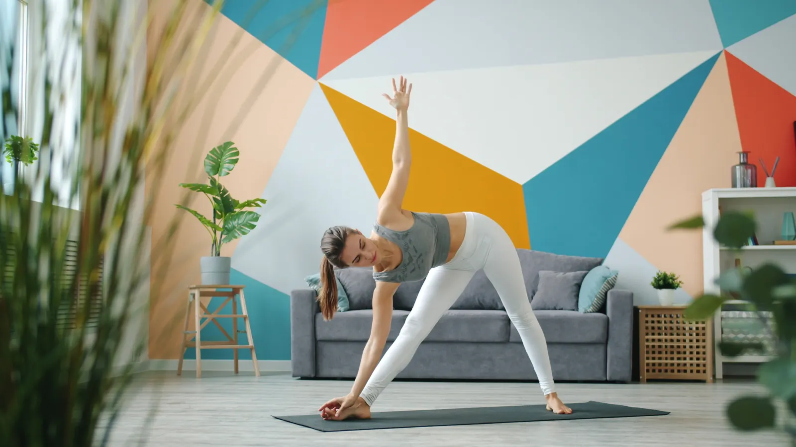 Woman practicing yoga indoors on a mat