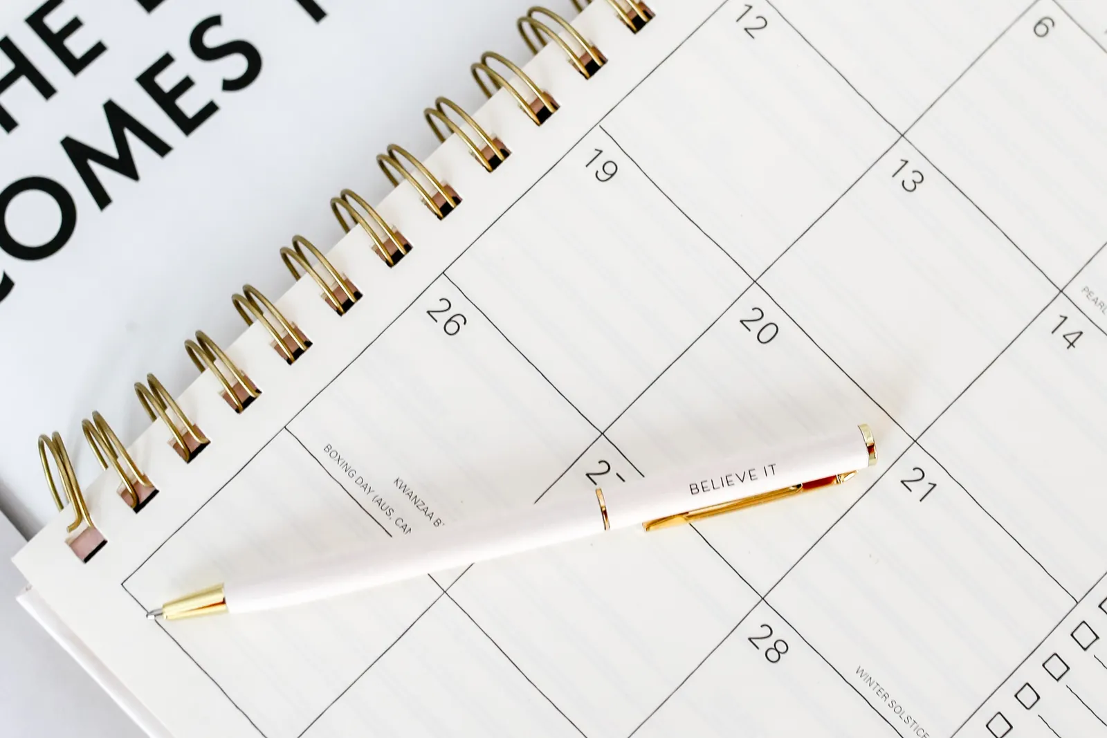 Planning a workout schedule with a calendar and pen