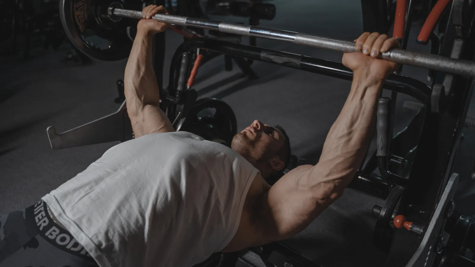 Athlete pressing a barbell on a bench