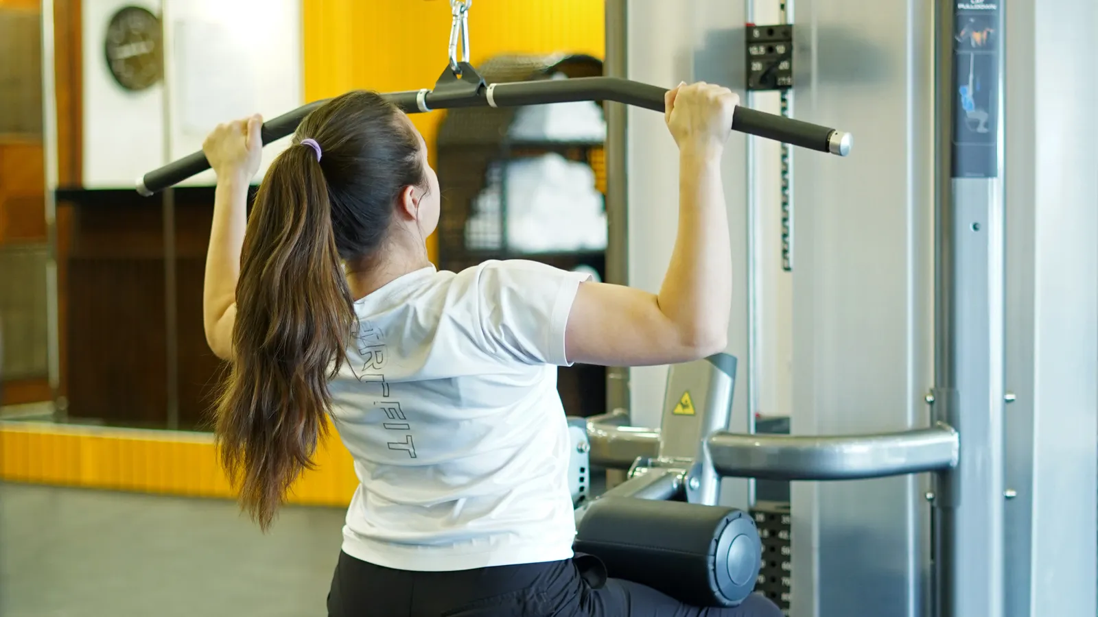 Person performing a lat pulldown