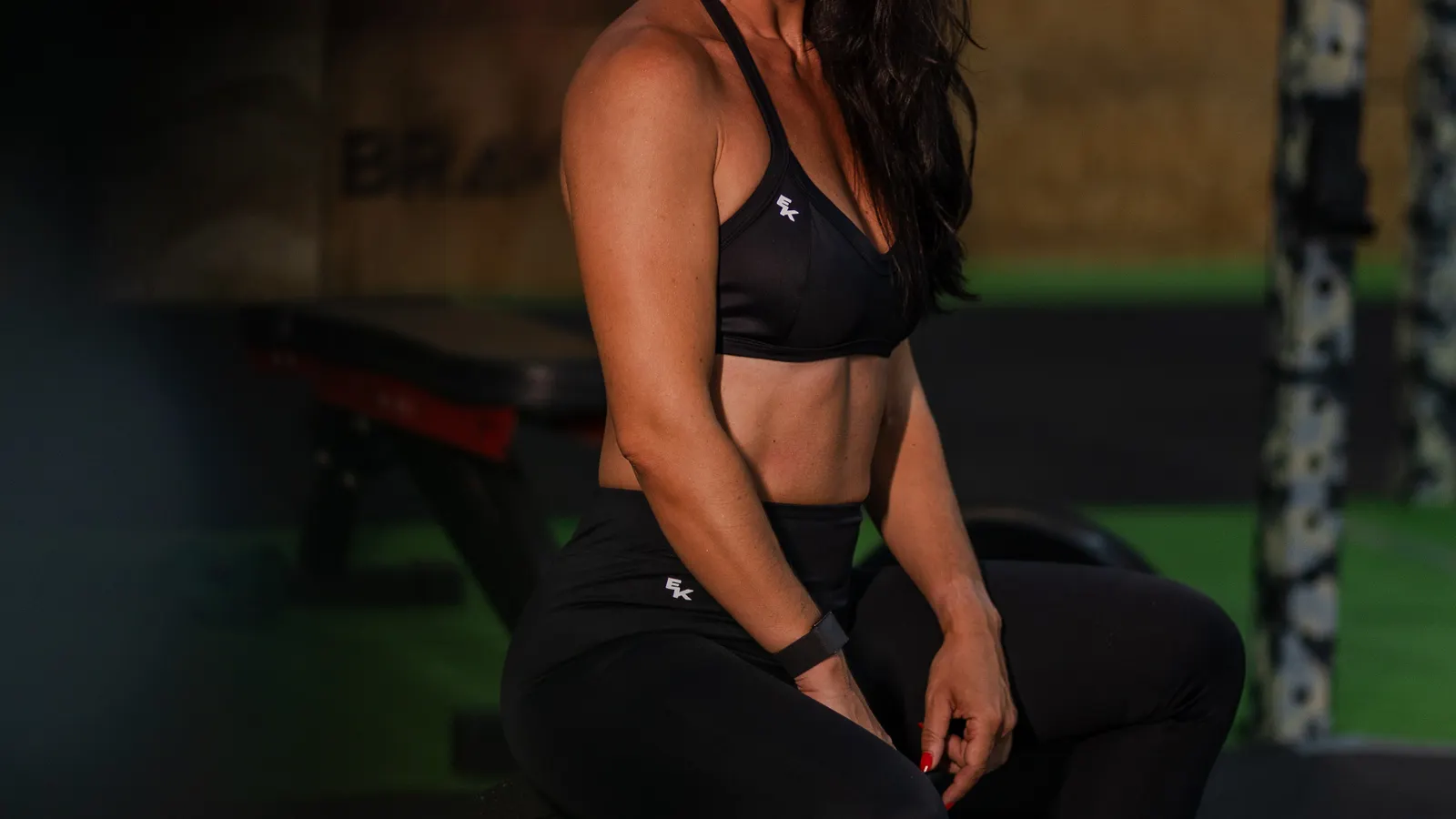 Woman posing confidently after training in the gym
