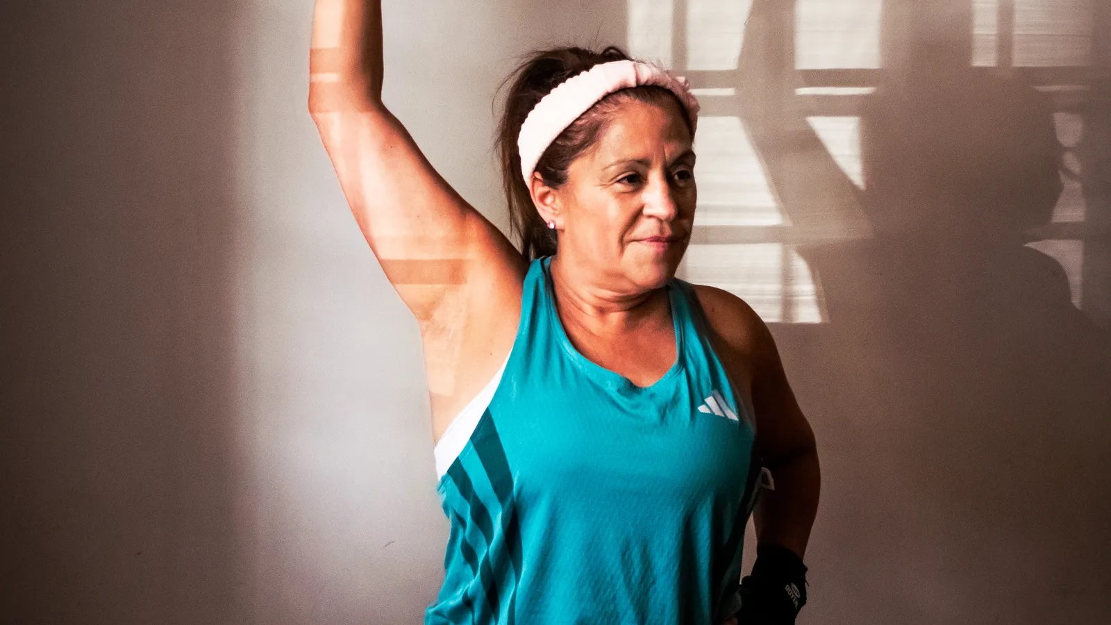 Woman training with dumbbells at home