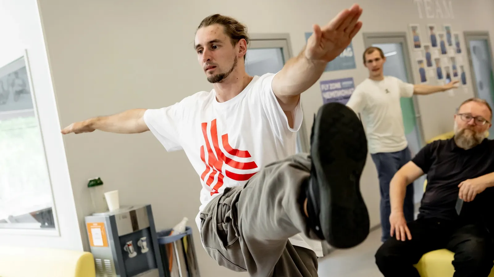 Man balancing during an indoor group fitness class