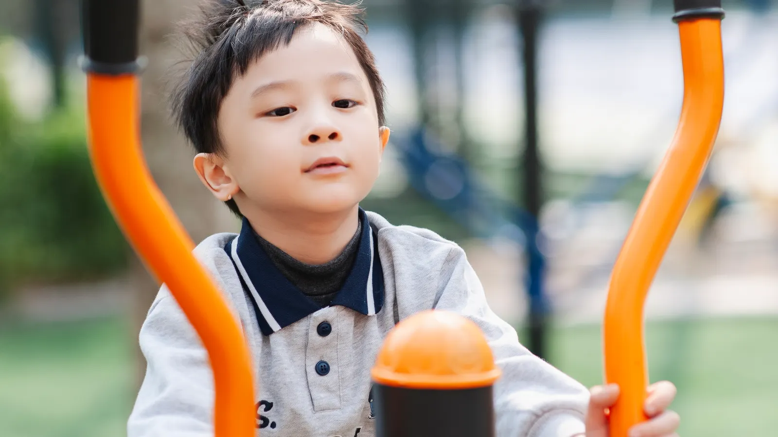 Child training on outdoor fitness equipment